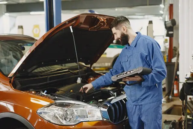 A technician analyzing the errors using a OBD scanner